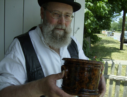 Board member holding Mehwaldt pottery